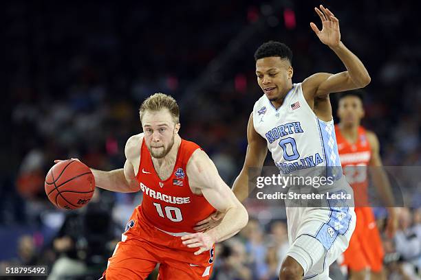 Trevor Cooney of the Syracuse Orange dribbles the ball against Nate Britt of the North Carolina Tar Heels in the second half during the NCAA Men's...