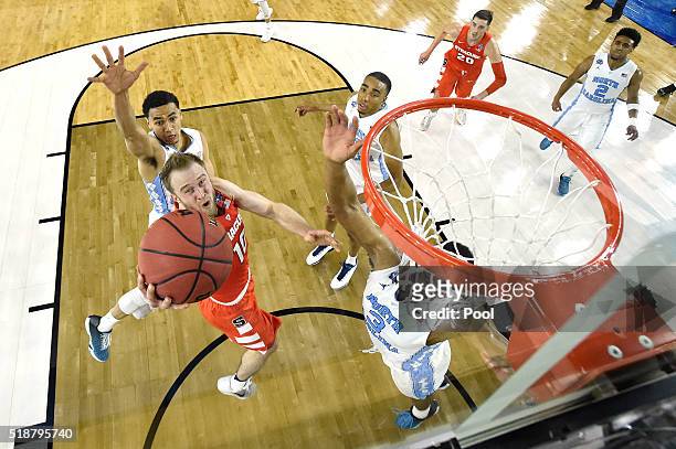 Trevor Cooney of the Syracuse Orange drives to the basket in the second half against the North Carolina Tar Heels during the NCAA Men's Final Four...