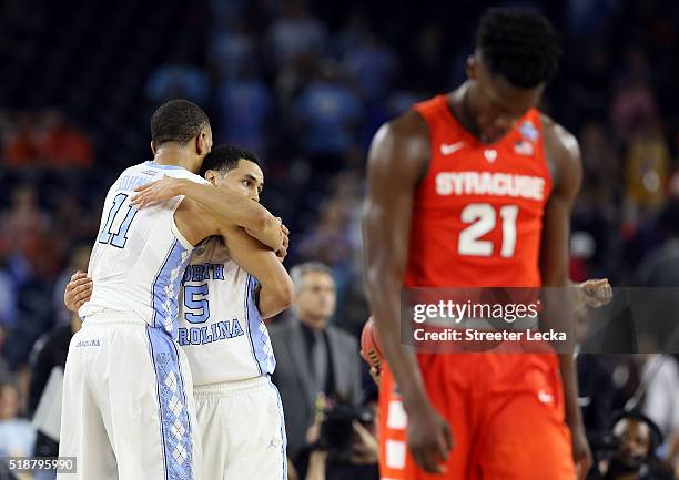 Brice Johnson of the North Carolina Tar Heels and Marcus Paige celebrate defeating the Syracuse Orange 83-66 as Tyler Roberson of the Syracuse Orange...