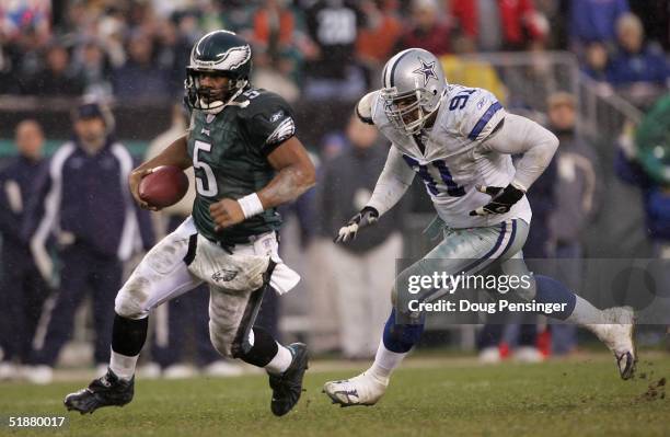 Donovan McNabb of the Philadelphia Eagles scrambles for a first down as he eludes Leonardo Carson of the Dallas Cowboys during the Eagles game...