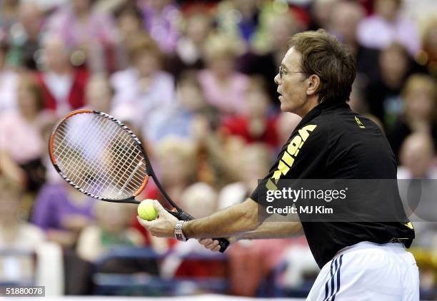 Sir Cliff Richard takes part in the "Intelligent Finance Cliff Richard Tennis Classic" at Birmingham National Indoor Arena on December 18, 2004 in...