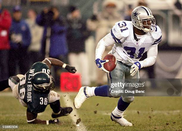 Safety Roy Williams of the Dallas Cowboys avoids a tackle by running back Brian Westbrook of the Philadelpia Eagles after Williams intercepted a pass...