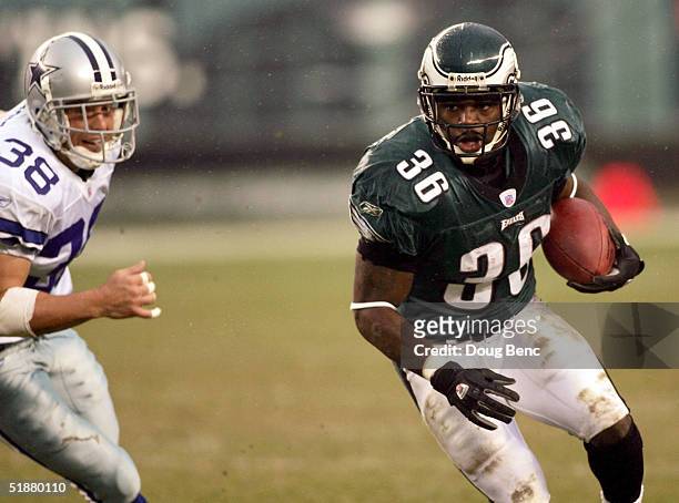 Running back Brian Westbrook of the Philadelpia Eagles avoids a tackle by safety Lynn Scott of the Dallas Cowboys at Lincoln Financial Field on...