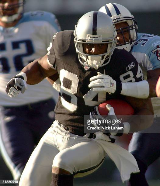 Wide receiver Jerry Porter of Oakland Raiders runs after a reception against cornerback Michael Waddell of the Tennessee Titans on December 19, 2004...