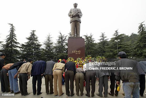Visitors pay their respects to Communist China's former top leader Mao Zedong, bowing in front of a statue in Mao's hometown of Shaoshan, 28 October...