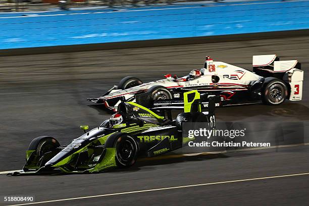 Charlie Kimball, driver of the Tresiba Chip Ganassi Racing Chevrolet IndyCar spins out as Helio Castroneves of Brazil, driver of the Team Penske...