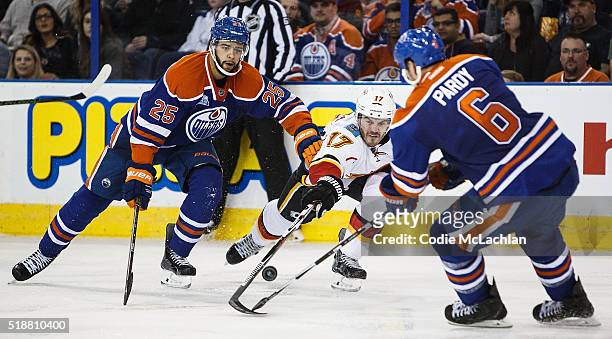 Darnell Nurse and Adam Pardy of the Edmonton Oilers battle against Lance Bouma of the Calgary Flames on April 2, 2016 at Rexall Place in Edmonton,...