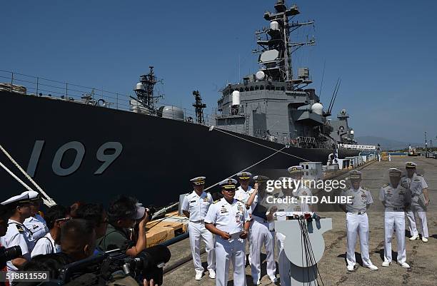 Japanese navy captain Hiraoki Yoshino speaks while his colleagues and their Philippine counterparts listen during a press conference next to Japanese...