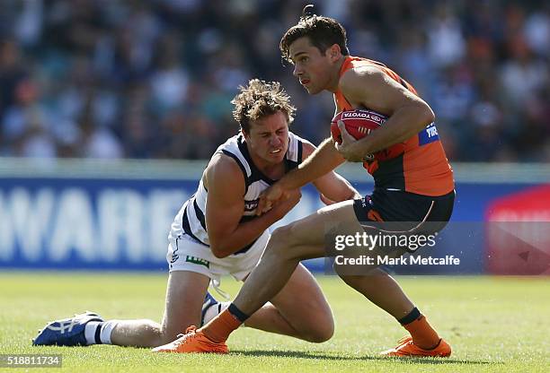 Josh Kelly of the Giants is tackled by Mitch Duncan of the Cats during the round two AFL match between the Greater Western Sydney Giants and the...