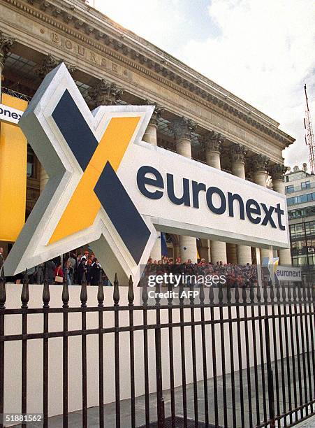 This photo taken 22 September 2004 shows Paris Stock Exchande employees rally at the Palais Brongniart in Paris, to mark birth of Euronext NV. The...