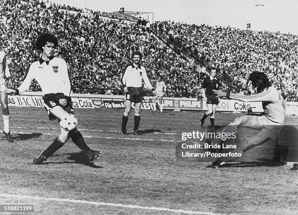 Roberto de Oliveira of Brazil, shoots for goal, avoiding a block from Bruno Pezzey of Austria during a World Cup Group 4 match at Estadio José Maria...