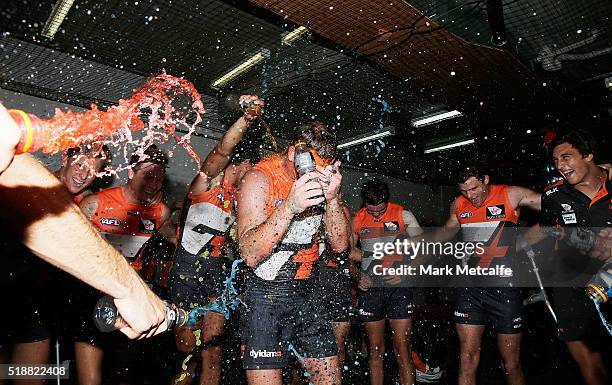 Steve Johnson of the Giants is sprayed with drinks by team mates after victory in the round two AFL match between the Greater Western Sydney Giants...