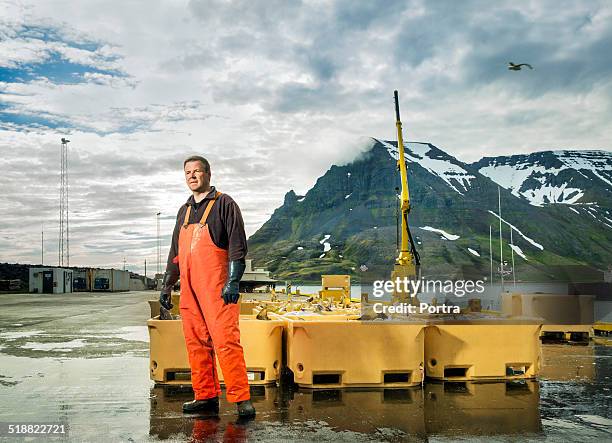 fisherman standing at fishing industry - fisherman stock pictures, royalty-free photos & images