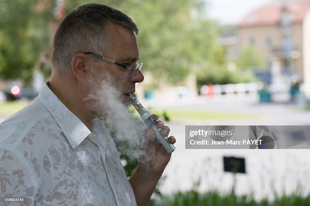 Man with casual look smoking E-Cigarette