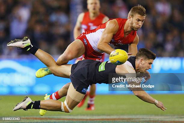 Kieren Jack of the Swans tackles Marc Murphy of the Blues during the round two match between the Carlton Blues and Sydney Swans at Etihad Stadium on...