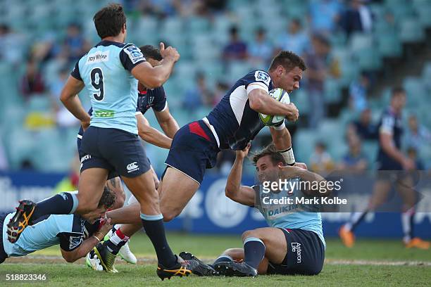 Mitch Inman of the Rebels is tackled by Zac Guildford of the Waratahs during the round six Super Rugby match between the New South Wales Waratahs and...