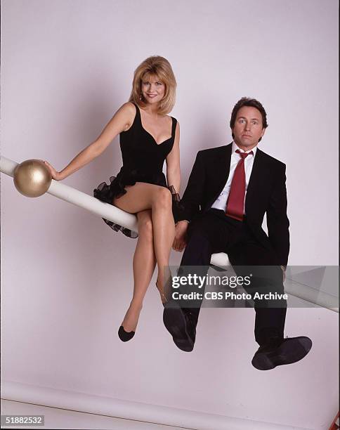 American actors Markie Post & John Ritter sit on a rail as they pose together in a promotional still from the television series 'Hearts Afire,' 1992.