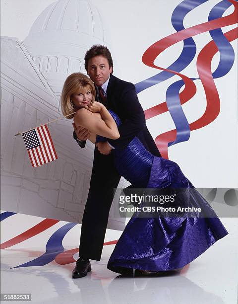 American actors Markie Post & John Ritter pose together in a promotional still from the television series 'Hearts Afire,' 1992. Ritter dips Post in a...