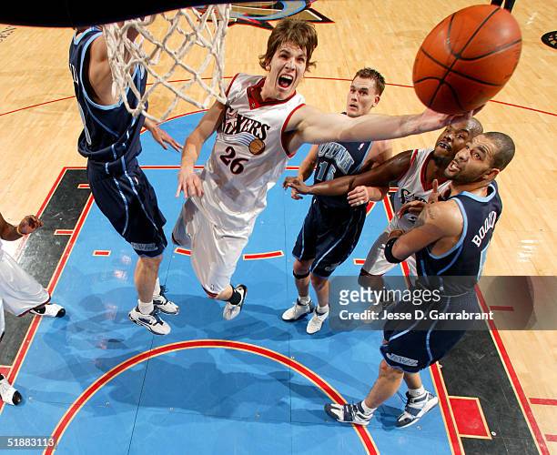 Kyle Korver of the Philadelphia 76ers lays one up past the defense of the Utah Jazz on December 20, 2004 at the Wachovia Center in Philadelphia,...