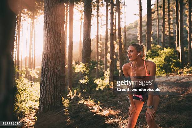 cross-country runner resting on a morning trail run on mountain - runner resting stock pictures, royalty-free photos & images