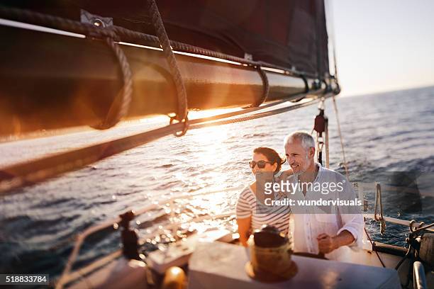 dreamy vintage shot of senior couple enjoying a leasure cruise - sailing boat bildbanksfoton och bilder