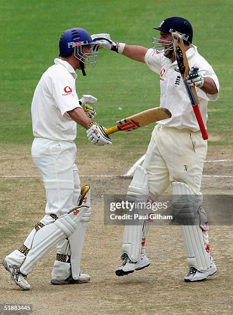 Andrew Strauss of England celebrates with Graham Thorpe after scoring the winning runs to give England victory during day five of the first Test...