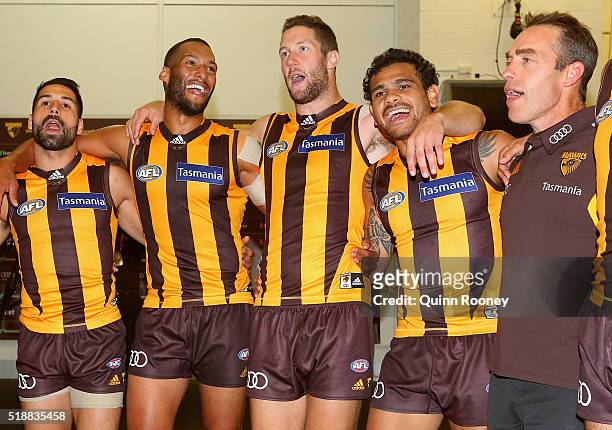 Paul Puopolo, Josh Gibson, James Frawley, Cyril Rioli and Alastair Clarkson of the Hawks sing the song in the rooms after winning the round two AFL...