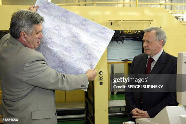 Ruslan Areshkovich , director of the banknotes printing house, shows newly-printed ballots that will be used in the nation's rerun presidential...