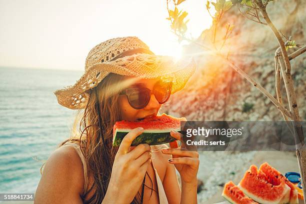eating and enjoying watermelon - summer heat temperature stock pictures, royalty-free photos & images