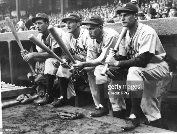 First baseman Hank Greenberg , outfielder Goose Goslin , second baseman Charlie Gehringer , and rightfielder Pete Fox of the Detroit Tigers hold...