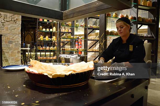 Woman making traditional Arabic flatbread, Saj, on April 02, 2016 in Dubai, United Arab Emirates.