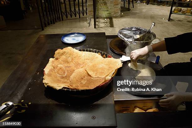 Woman making traditional Arabic flatbread, Saj, on April 02, 2016 in Dubai, United Arab Emirates.