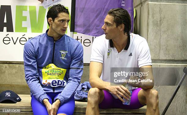 Winner Camille Lacourt and second Benjamin Stasiulis wait for the medals ceremony for the men's 100m backstroke final during day 5 of the French...