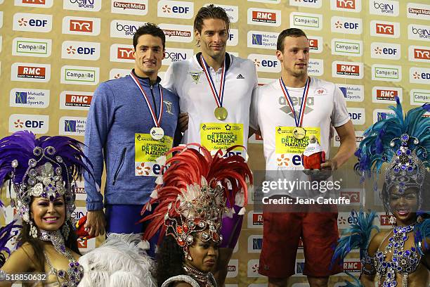 Winner Camille Lacourt , second Benjamin Stasiulis and third Eddie Moueddene pose on the men's 100m backstroke podium during day 5 of the French...