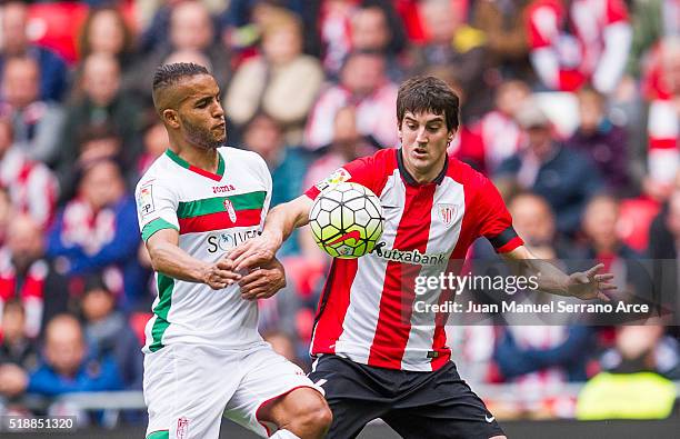 Mikel San Jose of Athletic Club Bilbao competes for the ball with Youssef El Arabi of Granada CF during the La Liga match between Athletic Club...