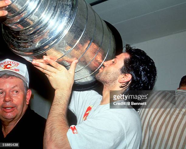 Canadian hockey player Doug Gilmour of the Calgary Flames kisses the Stanley Cup after a victory over the Montreal Canadiens in the Stanley Cup...