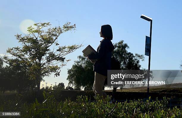 Overseas Chinese student Helen Zhou, from Chengdu, heads to Choir practice on campus at Linfield Christian School in Temecula, California on March...
