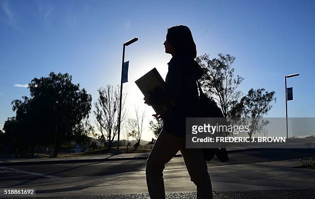 Chinese student Helen Zhou, from Chengdu, heads to Choir practice on campus at Linfield Christian School in Temecula, California on March 23, 2016....