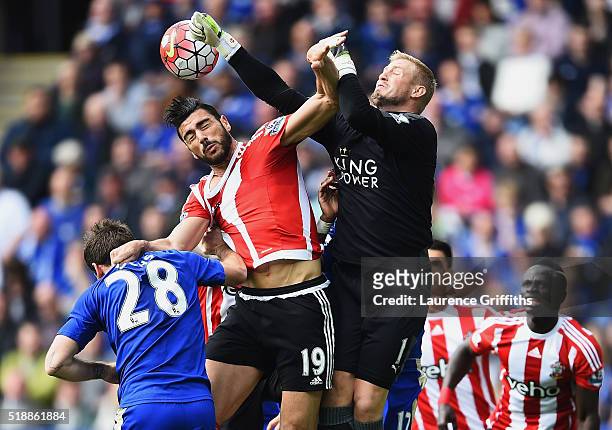 Goalkeeper Kasper Schmeichel of Leicester City attempts to punch clear from Graziano Pelle of Southampton during the Barclays Premier League match...
