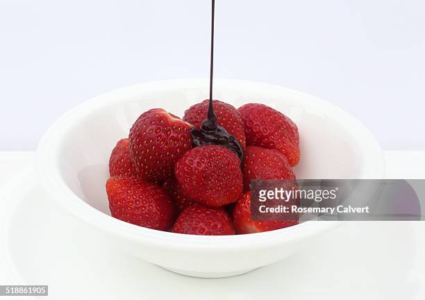 luxury of strawberries topped with dark chocolate - dark chocolate on white stock pictures, royalty-free photos & images