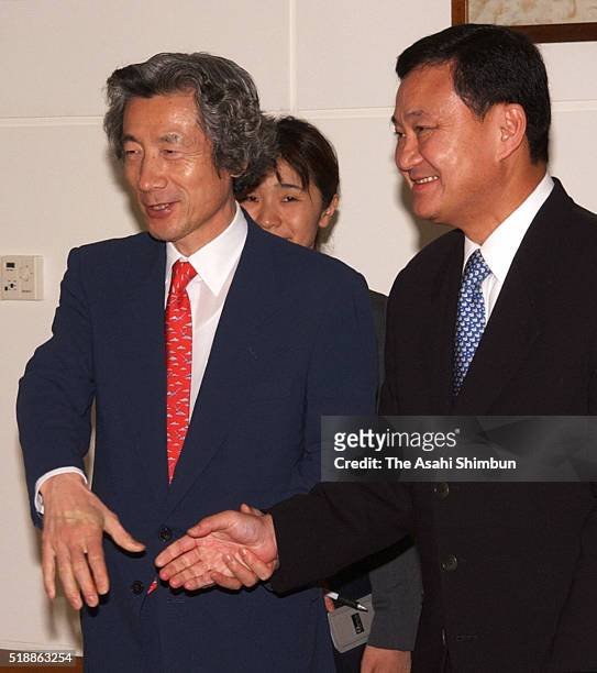 Japanese Prime Minister Junichiro Koizumi shakes hands with Thai Prime Minister Thaksin Shinawatra prior to their bilateral meeting on the sidelines...