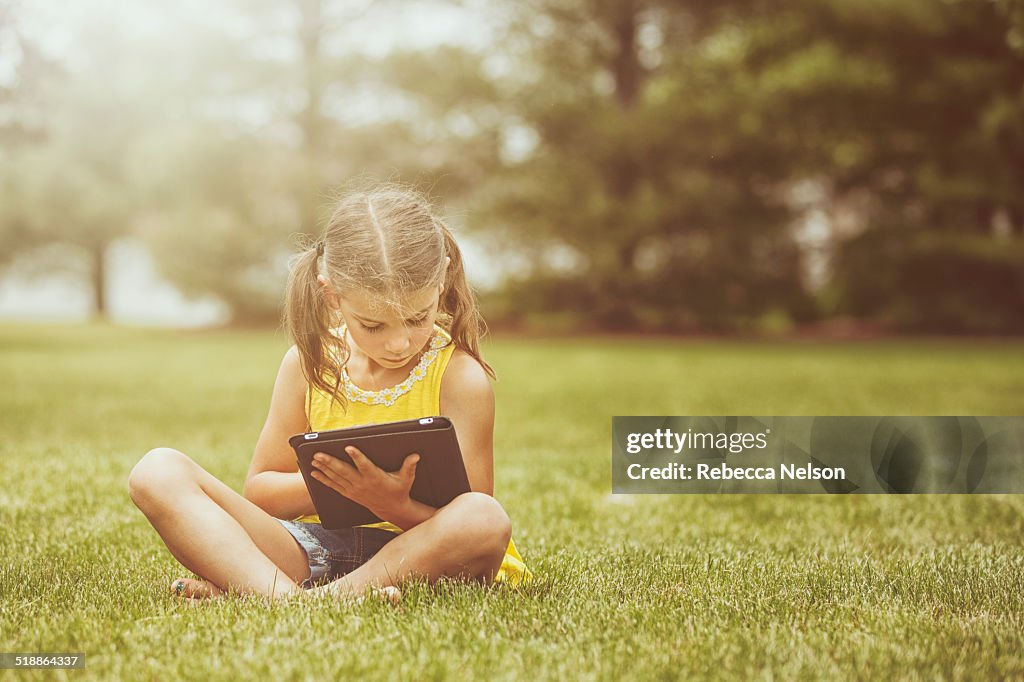 Girl using electronic tablet