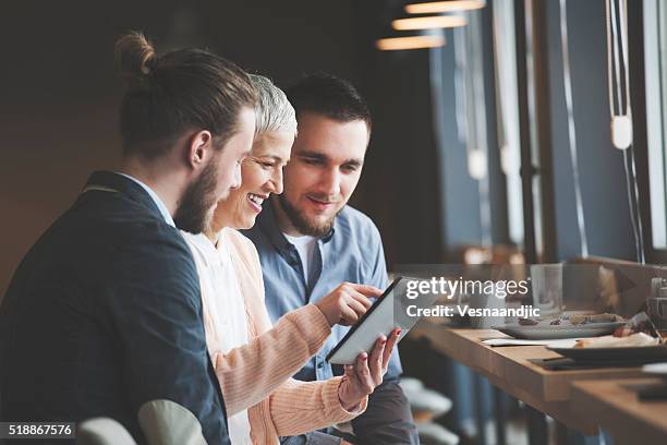 business people at cafe - woman holding restaurant menu stock pictures, royalty-free photos & images