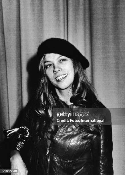 American singer songwriter Rickie Lee Jones wears a beret and leather jacket as she poses backstage with her Grammy Award for Best New Artist at the...