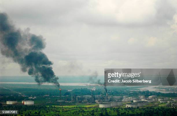 Smokes comes from the Eleme Refinery October 12, 2004 in Port Harcourt, Nigeria. This is one of only two working oil refineries in Nigeria. A member...