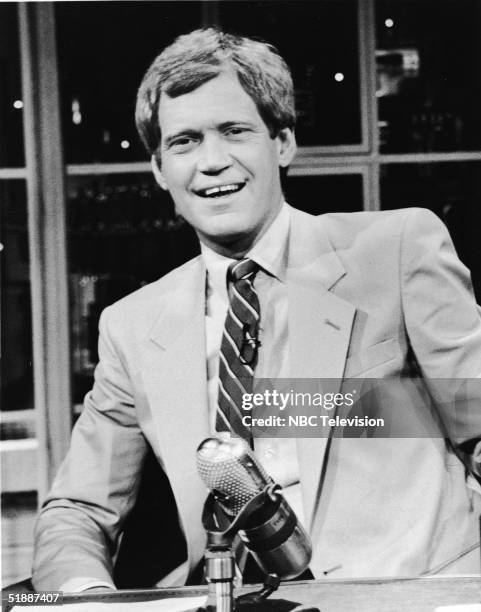 American talk-show host and comedian David Letterman sits at his desk on the television series 'Late Night with David Letterman,' New York, New York,...