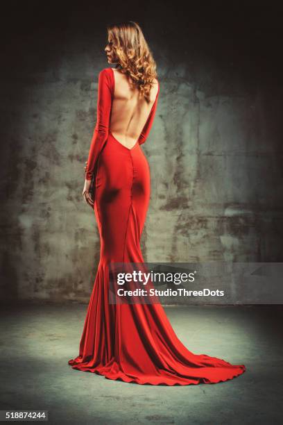 young beautiful woman in red dress - red dress model stock pictures, royalty-free photos & images