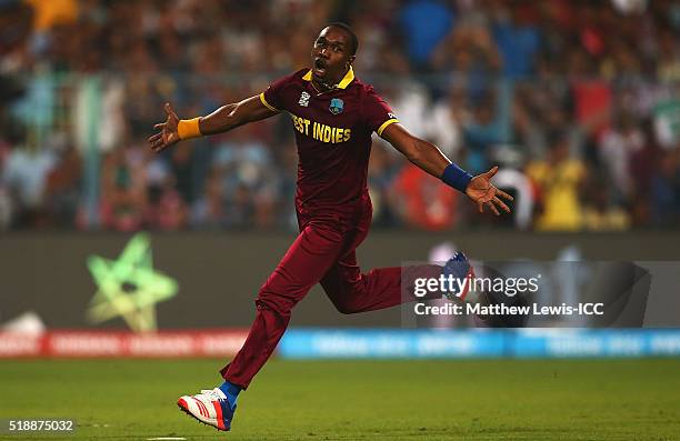 Dwayne Bravo of the West Indies celebrates the wicket of Moeen Ali of England, after he was caught by Denesh Ramdin of the West Indies during the ICC...