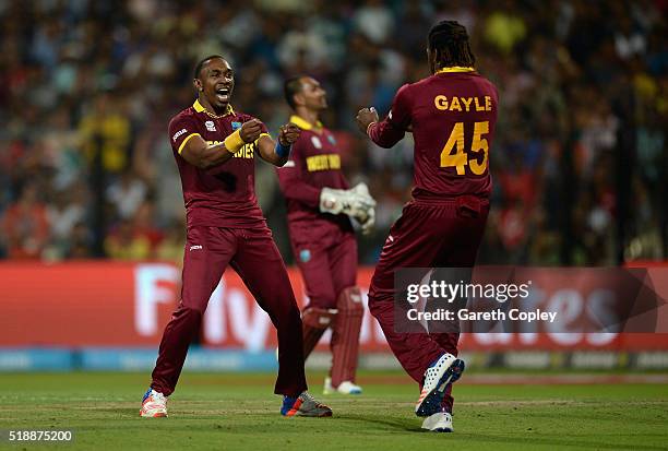 Dwayne Bravo of the West Indies celebrates with Chris Gayle after dismissing Ben Stokes of England during the ICC World Twenty20 India 2016 Final...