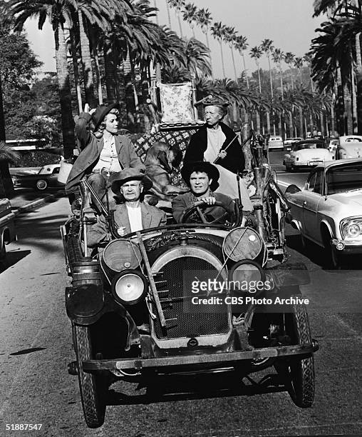 American actresses Donna Douglas and Irene Ryan and American actors Max Baer Jr. And Buddy Ebsen drive in a convertible car in an episode of the...